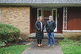 Michigan Fosters Executive Director Tiffany Kraker and Holland Heights CRC Parsonage Committee Chairman Kevin Anderson stand outside of what is soon to become Journey Home, a place for families navigating foster care.