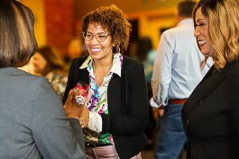 LaSandra Gaddy (center), the new president and CEO of the Grand Rapids Community Foundation (GRCF), talks to supporters.