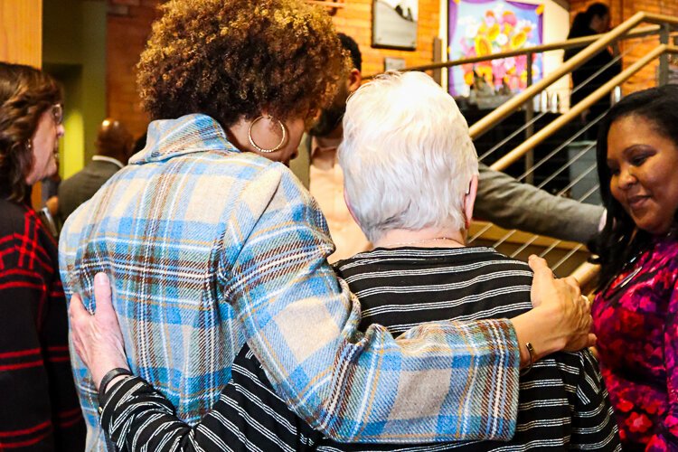 LaSandra Gaddy, the new president and CEO of the Grand Rapids Community Foundation (GRCF), left, hugs a supporter at a recent event.