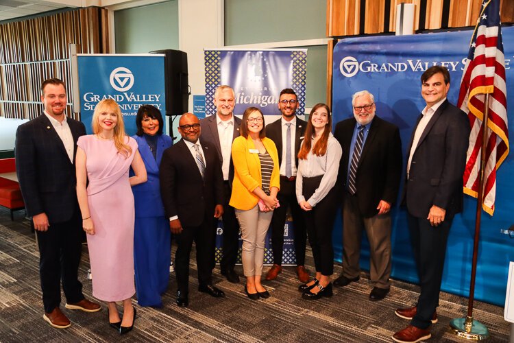 Grant winners, elected officials, and the Michigan Growth Office pose for an impromptu photo post-ceremony.