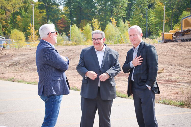 Progressive Companies' principal Jim Horman (on the right) talks universal design with members of the Winning Streak team, including Kent County Administrator Al Vanderberg (center).