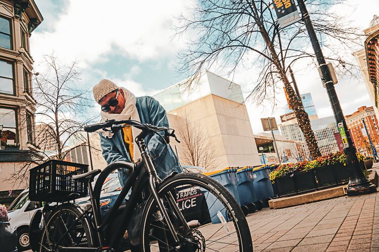 Ken Miguel-Cipriano locks up his bike at one of the city's designated spots.