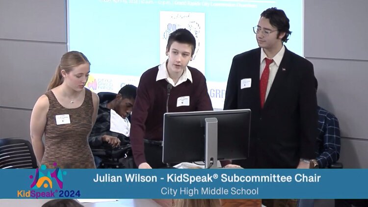 Julian Wilson (center) served as the KidSpeak chair in his junior year, where he led the forum, and believes it’s important for young people to get involved in government. 