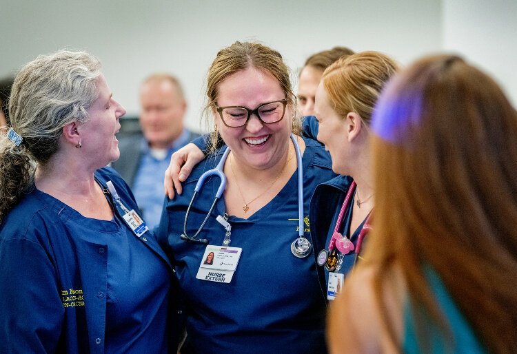 MCC nursning students share a laugh during during an event at Trinity Health Muskegon Hospital celebrating the nursing partnership Oct. 29.