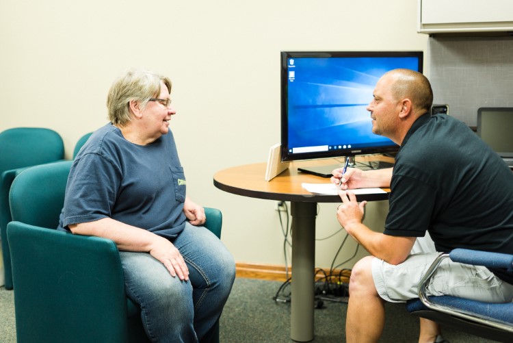 Lee Township resident Judy Wirtz confers with community health worker Jerry Burton.