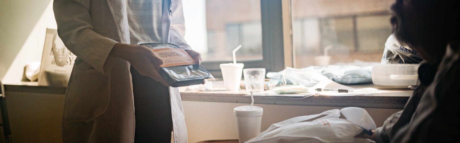 Sarah Berry, program manager for Beaumont Hospital, Troy, shows a medically tailored meal to a patient.