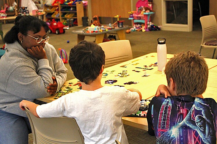 Boys play while a staff member supervises.