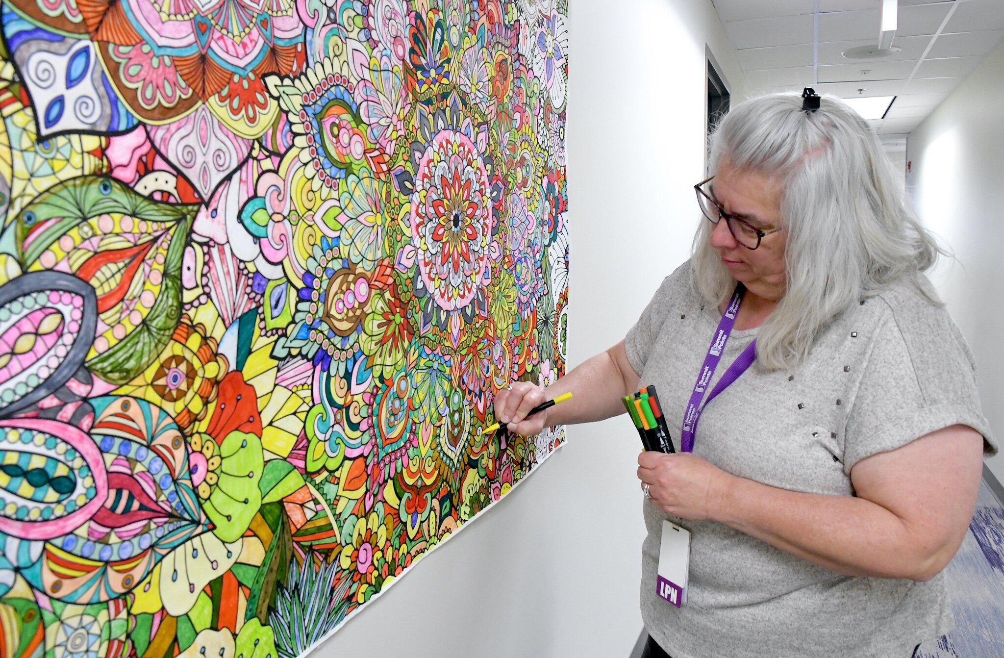 Kim Hargis, LPN works on a mandala mural at Summit Pointe.