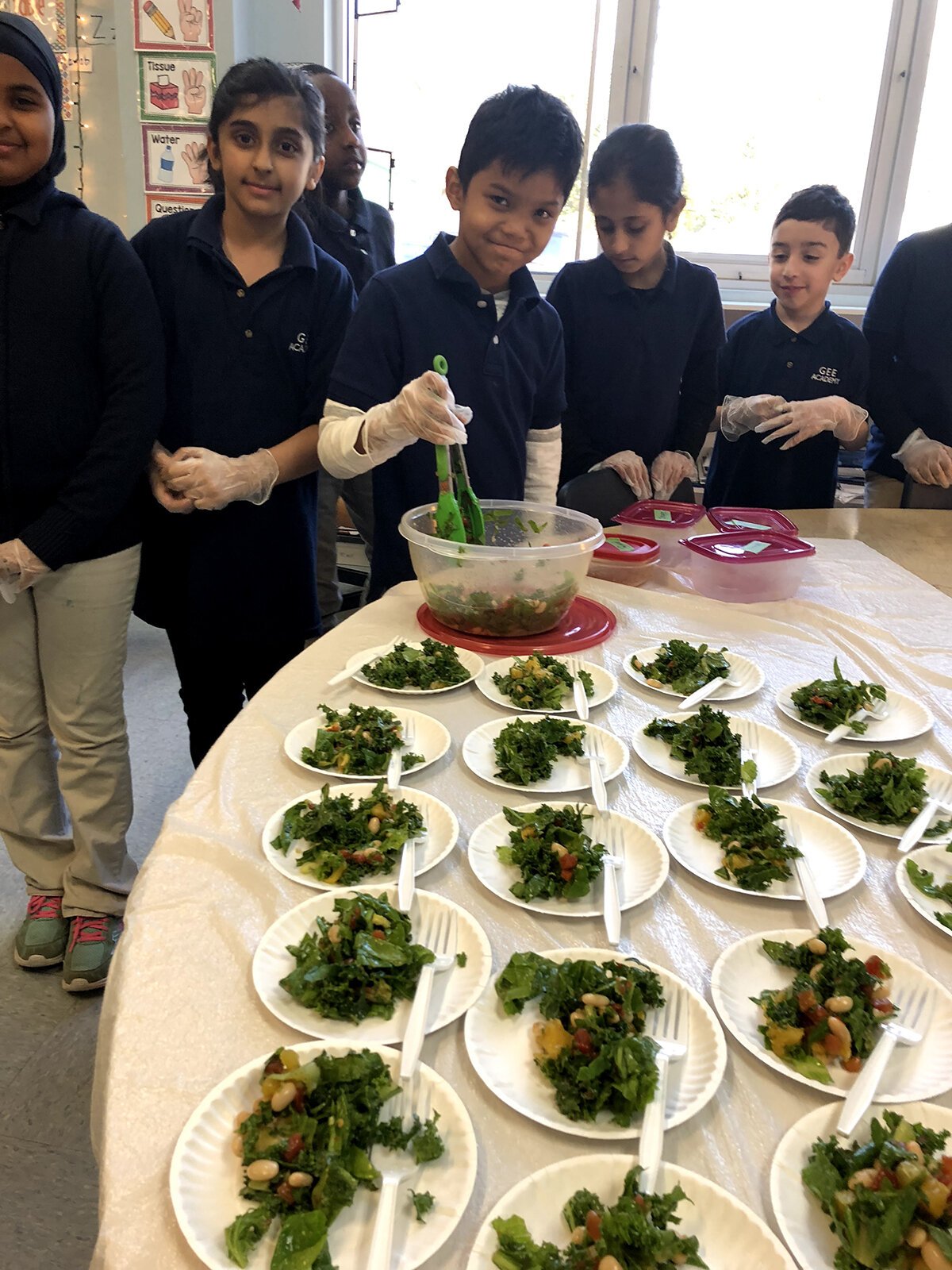 Students toss a healthy kale salad.